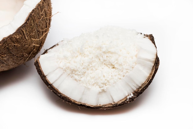 Coconuts with coconuts flakes isolated on the white background.