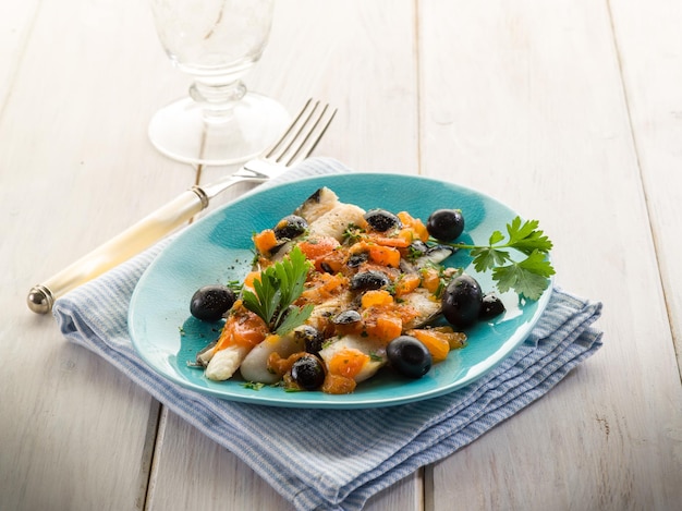 Cod fillet with black olives and fresh tomatoes