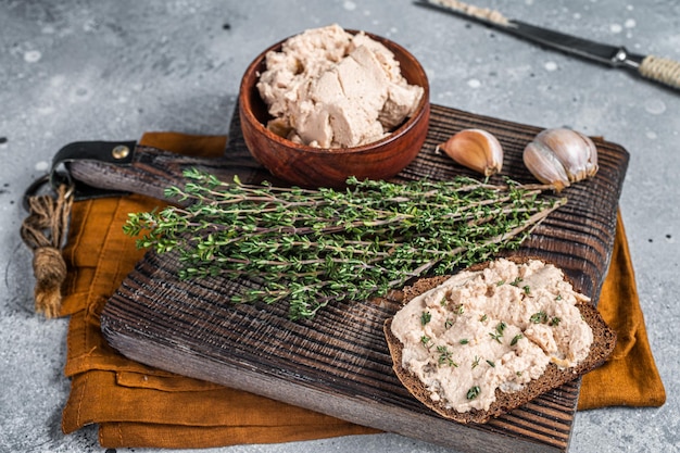 Cod liver sandwiches with liver on wooden board natural source of omega 3 gray background top view