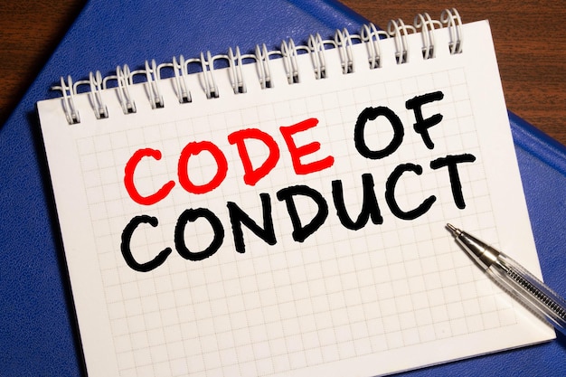 Photo code of conduct text written on notebook page red pencil on the right motivational concept image