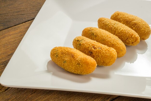 Codfish fritters or codfish cakes, a traditional appetizer in Portugal on white background