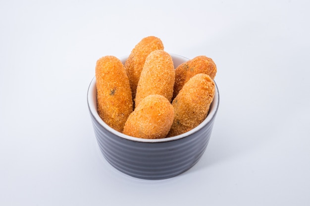 Codfish fritters or codfish cakes, a traditional appetizer in portugal on white background