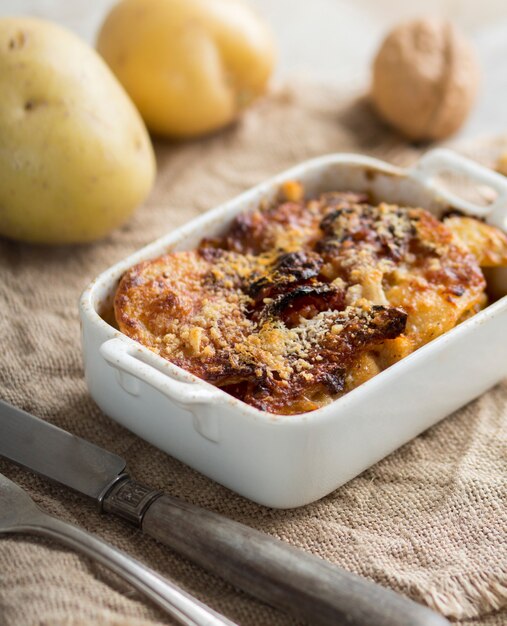 Codfish with potatoes baked in oven in a casserole. close up