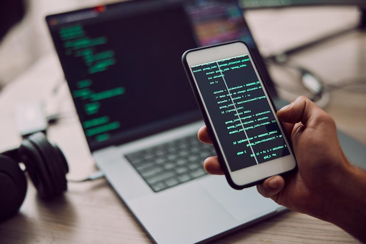Photo coding laptop and phone in hand with man programmer and software update information technology and code cybersecurity ux and network with wifi web design and cyber space with cpu programming