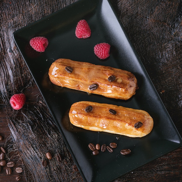 Coffe eclair with raspberries