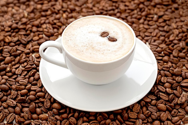 Coffee abstract creative coffee cup and coffee beans beans on warm neutral background