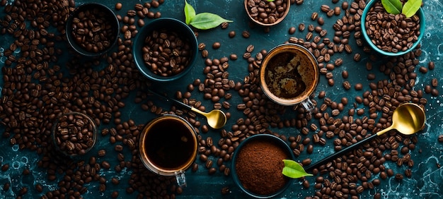 Coffee background Coffee in cups and coffee beans on a black stone background Top view Free space for text