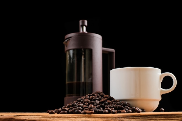 Coffee backgrounds, coffee cup and coffee french press on rustic wooden table with copy space