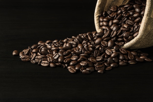 Coffee bean on black wood background