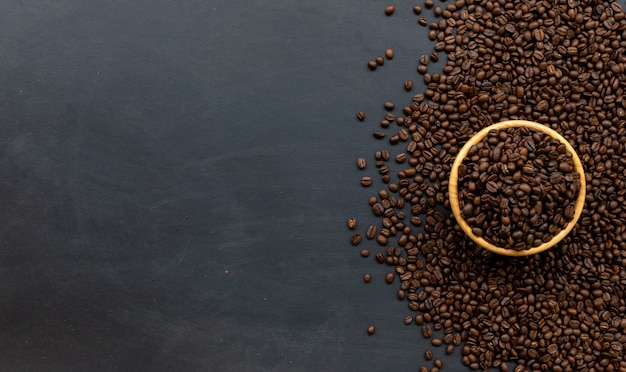 Coffee bean on black wooden floor background