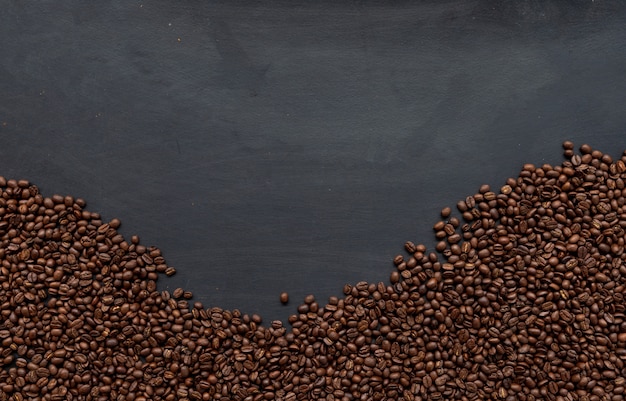 Coffee bean on black wooden floor background