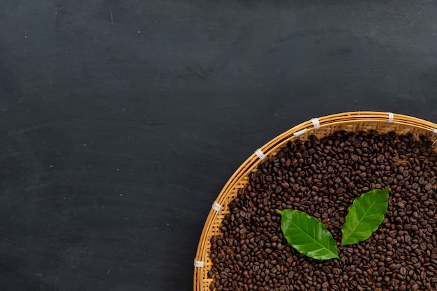 Coffee bean on black wooden floor background