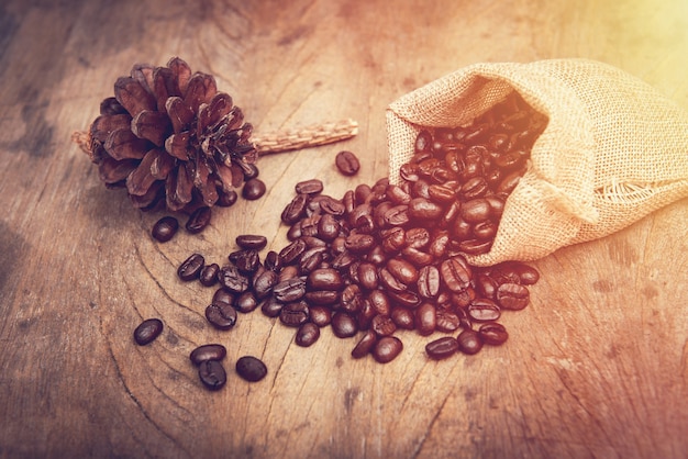 Coffee bean in burlap on wooden table