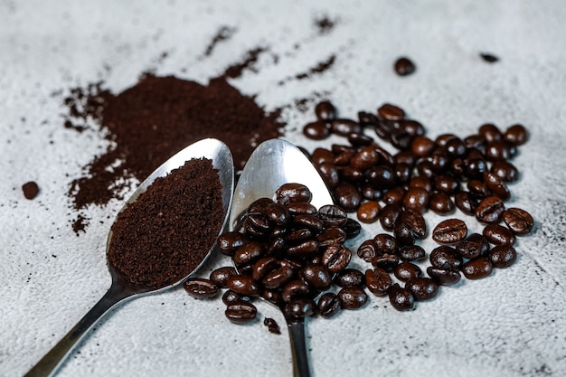 coffee bean and coffee powder on the spoon put them on stone backgrund, Good raw materials for making fresh coffee