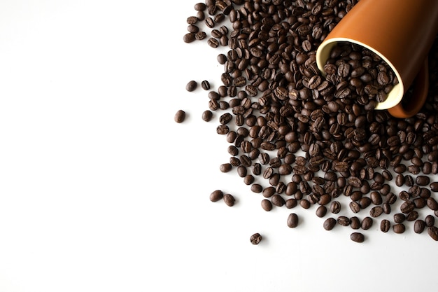 Coffee bean in cup on white table 