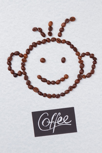 Coffee beans arranged in a shape of smiling boy