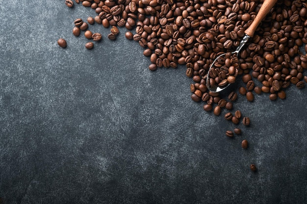 Coffee beans background roasted coffee beans on dark black
stone background top view coffee concept mock up