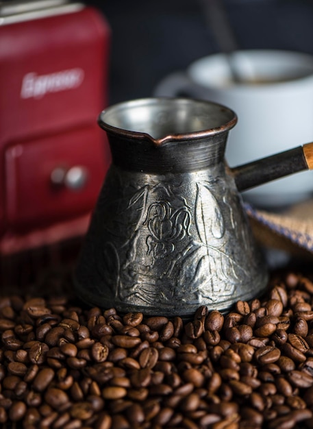 Coffee beans next to bag and coffee grinder