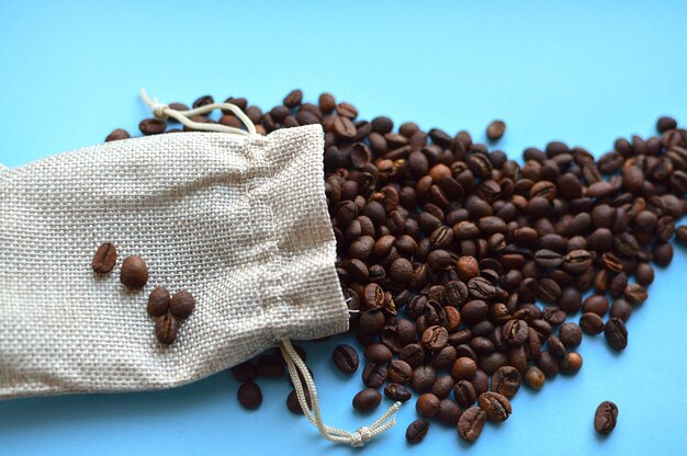 Coffee beans in bag isolated on blue background