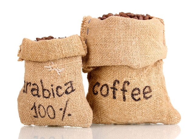 Coffee beans in bags on white