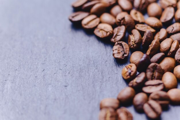 coffee beans on black stone background with empty place