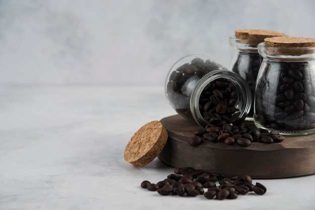 Coffee beans in bootle on wood plate