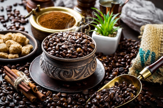 Coffee beans in a bowl and cinnamon sticks