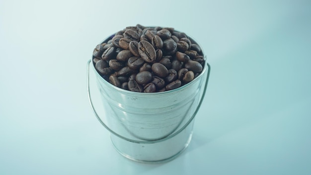 Coffee beans in the bucket isolated on a white background Selective focus concept