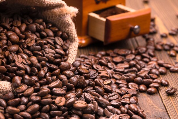 Coffee beans in burlap sack on a wooden