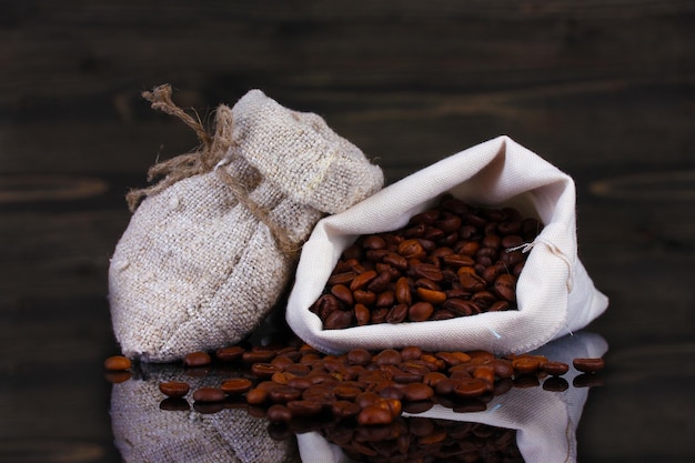 Coffee beans in canvas sack isolated on wooden