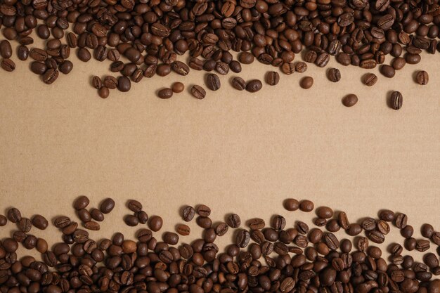 Coffee beans on a cardboard background, copy space.