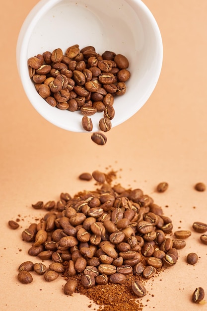 Coffee beans in coffee cup on pastel background Space fot text