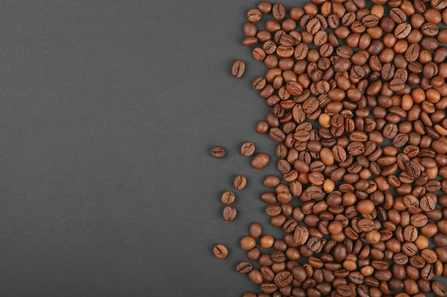 Coffee beans on a colored background place to insert text minimalism