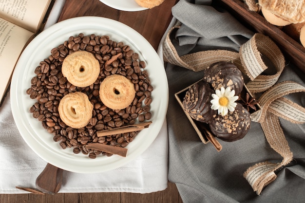 Chicchi di caffè, biscotti e praline di cioccolato. vista dall'alto