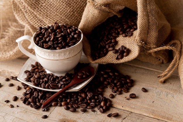 Coffee beans in cup and burlap sacks