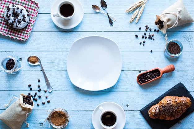 Coffee beans and cup of coffee, breakfast top view