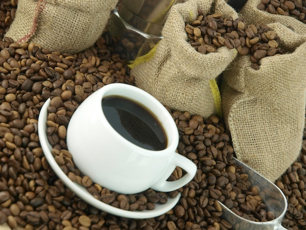 Coffee beans and a cup of coffee on a table