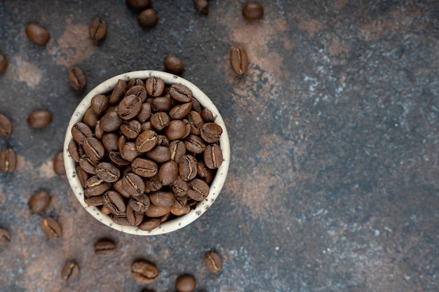 Coffee beans in a cup. Top view.