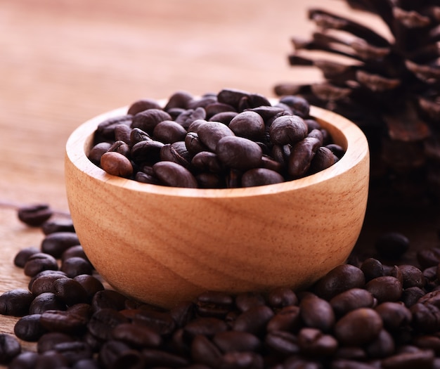 Coffee beans in a cup Wood background