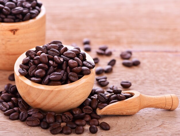 Coffee beans in a cup Wood background