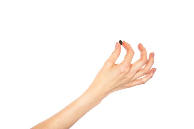 Coffee beans in female hands isolated on white background