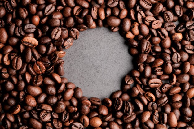 Coffee beans frames at dark gray background. Copy space