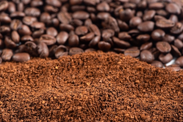 Photo coffee beans and grounds.roasted coffee beans and grounds close up from above selective focused.