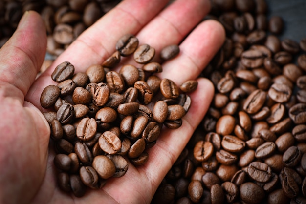 Coffee beans in hand and coffee bean roasted