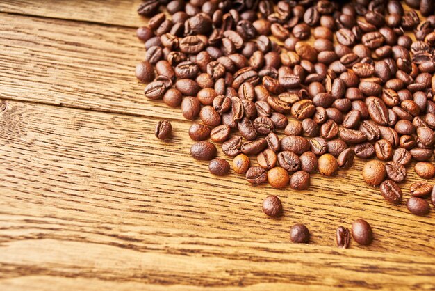 coffee beans Hot drink spilled grains wood background. High quality photo