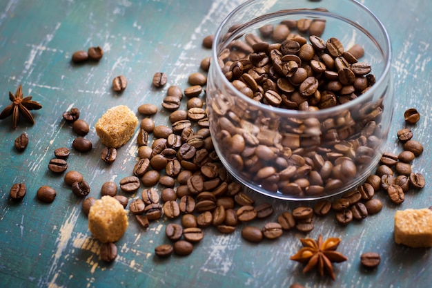 Coffee beans in jar and loose on the old Shabby background