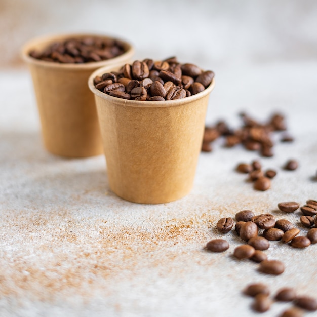 Coffee beans in a paper cup fresh roasted grain serving arabica or robusta