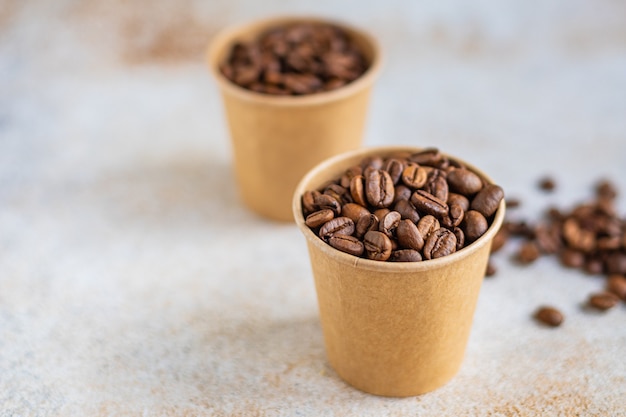 Coffee beans in a paper cup fresh roasted grain serving arabica or robusta