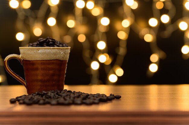 Coffee beans Placed on the desk Orange bokeh floor scene