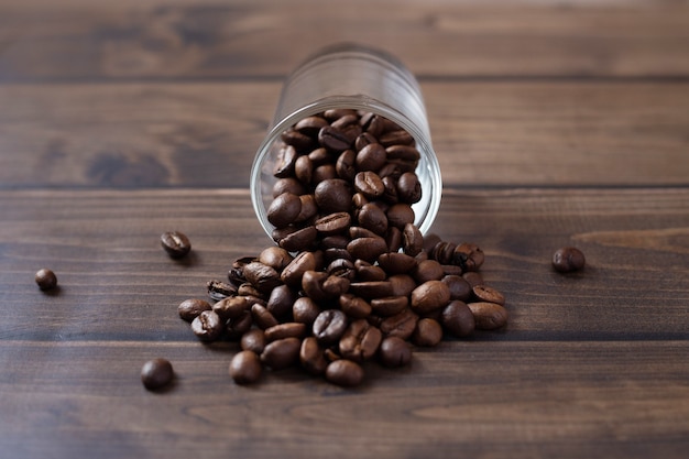 Coffee beans pouring out from a glass